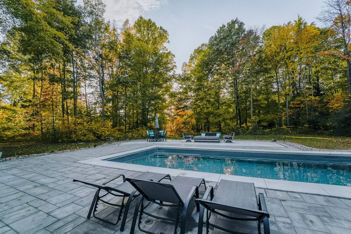 Heated in-ground saltwater pool set in a pale stone patio