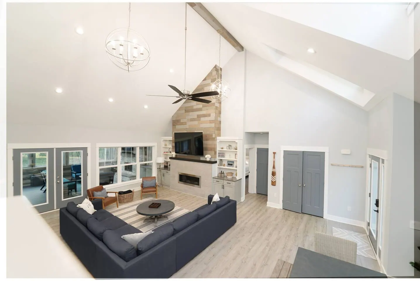 Open living area with fireplace, ceiling fan, and garden views