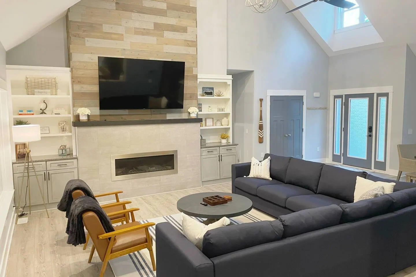 Living room fireplace and media wall in light stone and wood
