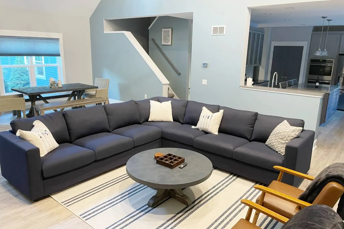 Sectional sofa arranged around a round coffee table
