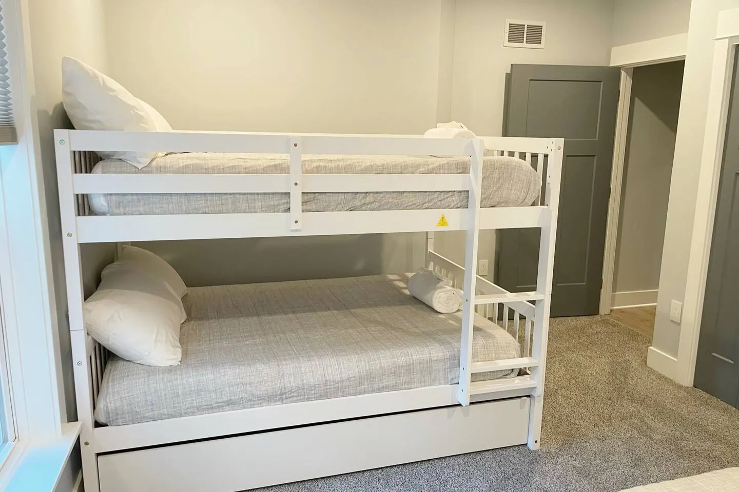 White full-over-full bunk bed made with crisp linens