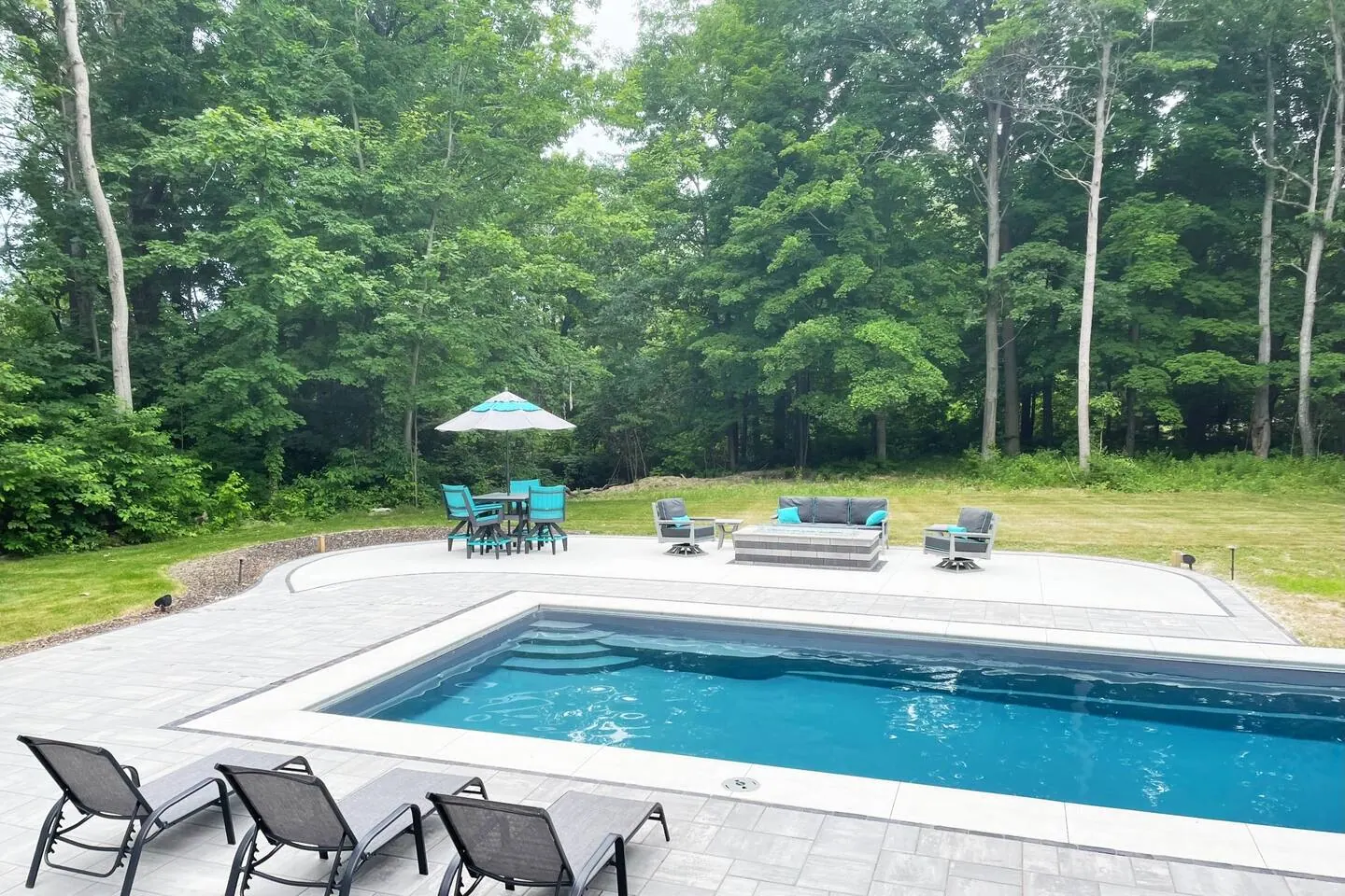 Full length of the pool with chairs along the far edge