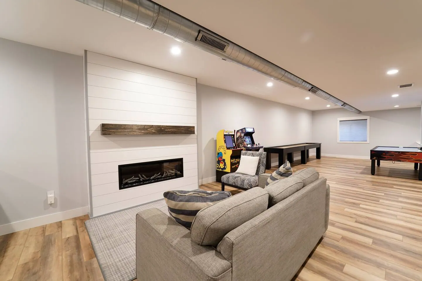 Basement seating facing a large television and chalkboard wall
