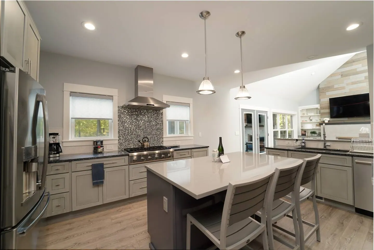 Kitchen island with seating and a view into the living room
