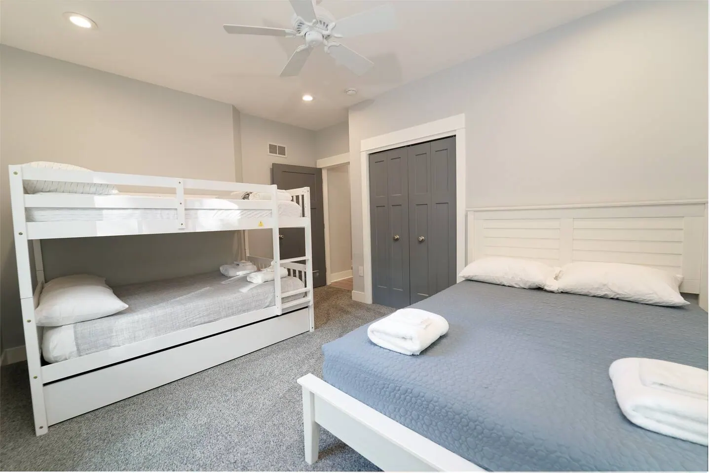 Bedroom with a queen bed and a full-over-full bunk beside it