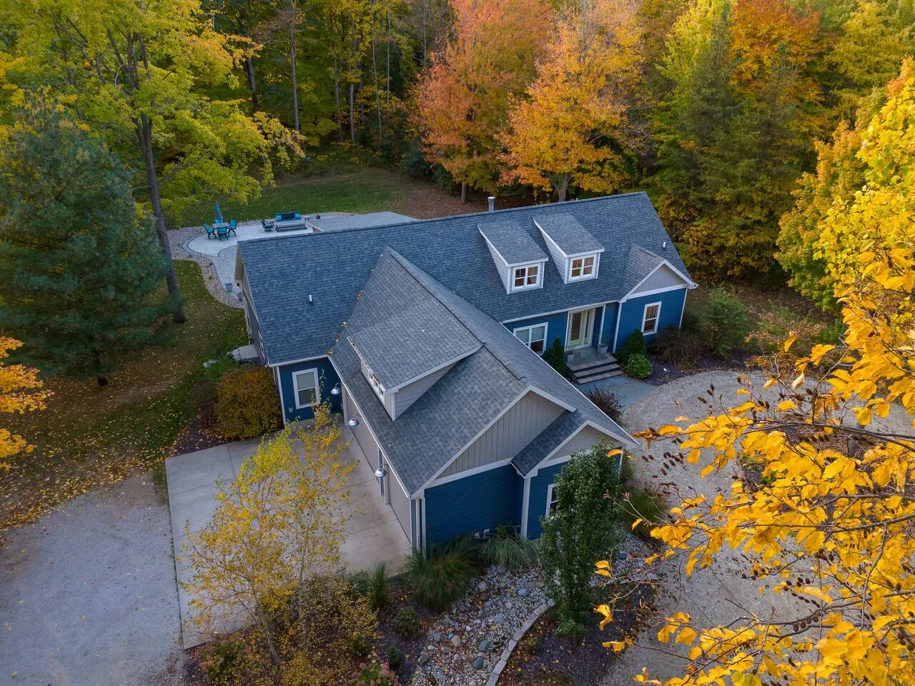 Overhead view of the house roof and surrounding woodland